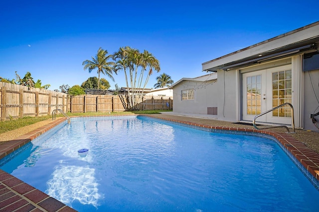 view of pool featuring french doors