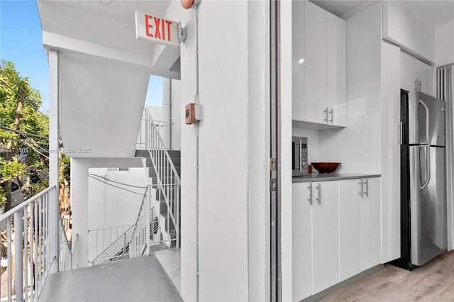 exterior space featuring white cabinets and appliances with stainless steel finishes