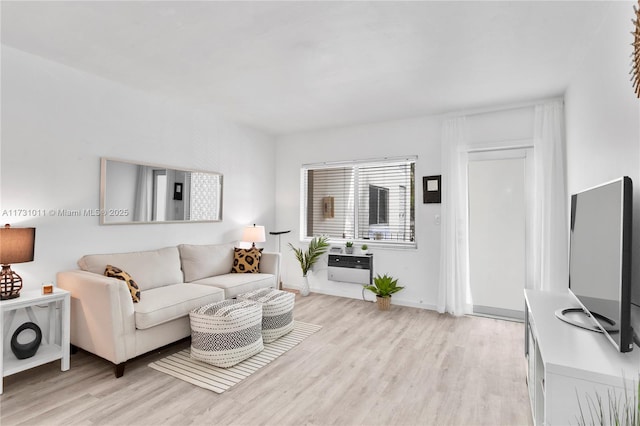 living room featuring light wood-type flooring and heating unit