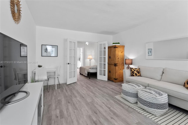 living room with light hardwood / wood-style floors and french doors