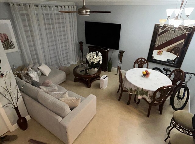 living room with ceiling fan with notable chandelier