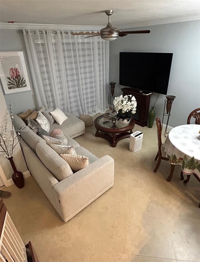 living room with ceiling fan and crown molding