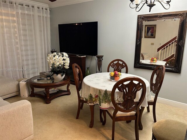 dining space with ornamental molding and an inviting chandelier