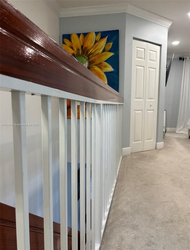 hall featuring crown molding and light colored carpet