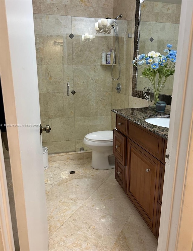 bathroom with vanity, toilet, walk in shower, and tile walls