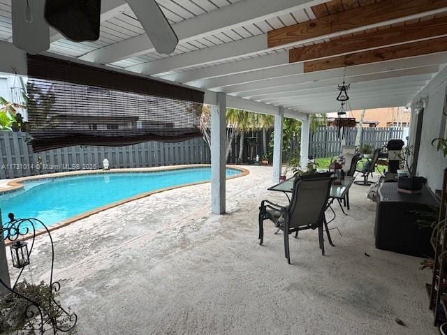 view of pool with ceiling fan and a patio