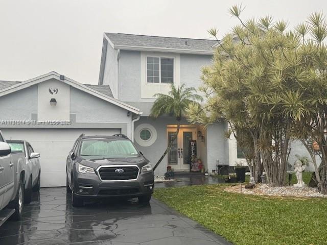 view of front facade with a garage and a front yard