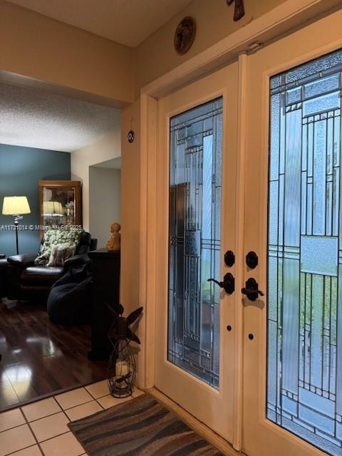 doorway with tile patterned floors