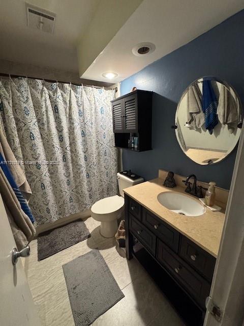 bathroom featuring toilet and vanity