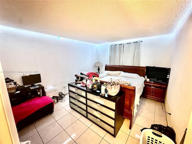 tiled bedroom featuring a textured ceiling