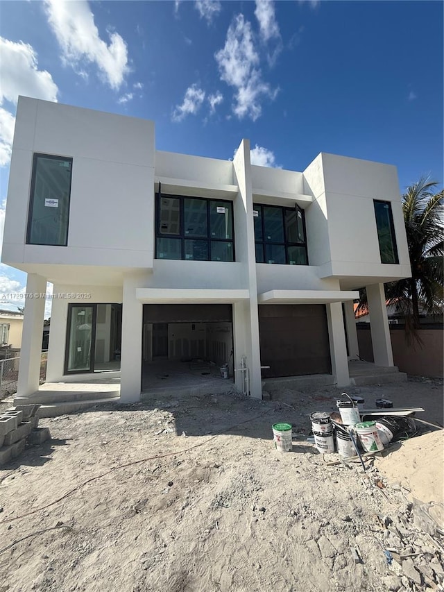 rear view of house with a garage