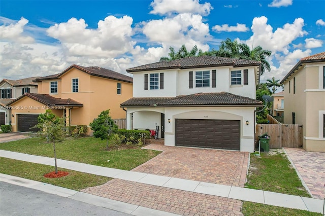 mediterranean / spanish-style home with a garage and a front yard