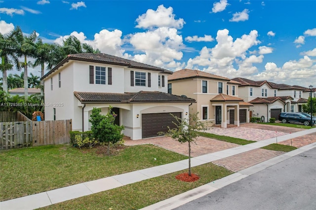 mediterranean / spanish-style home with a garage and a front lawn