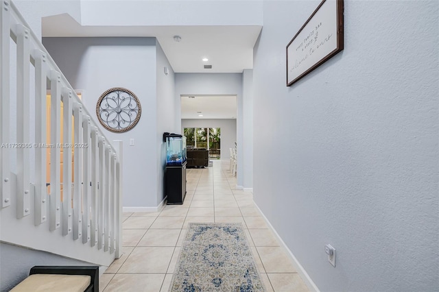 corridor with light tile patterned floors