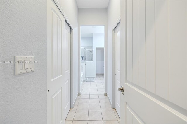 hall with light tile patterned floors