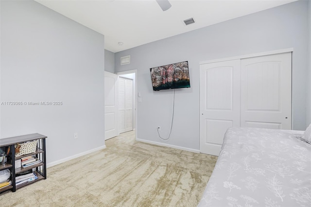 carpeted bedroom with a closet and ceiling fan