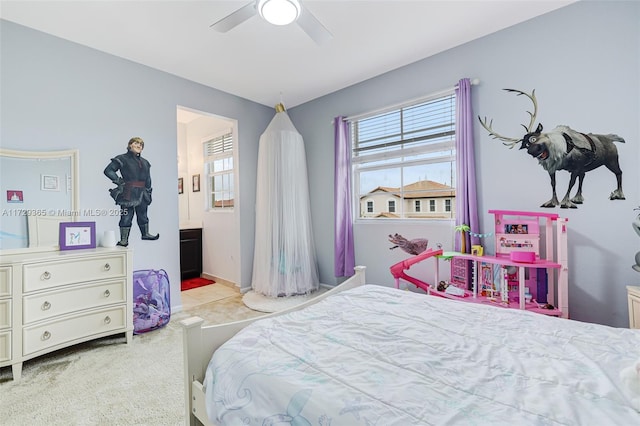 bedroom with ceiling fan and light carpet