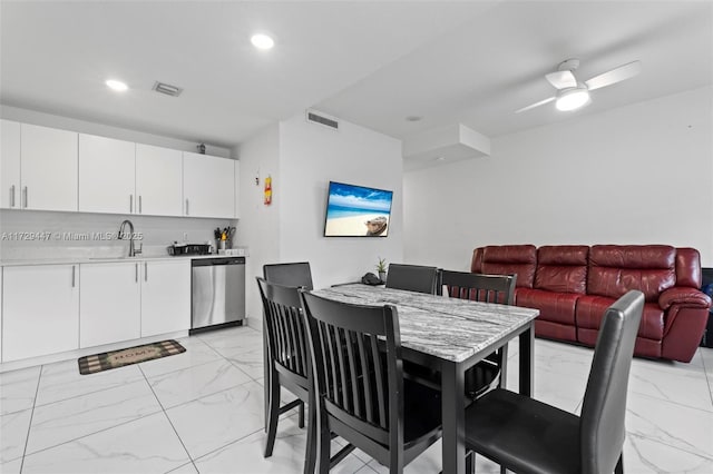 dining room featuring sink and ceiling fan