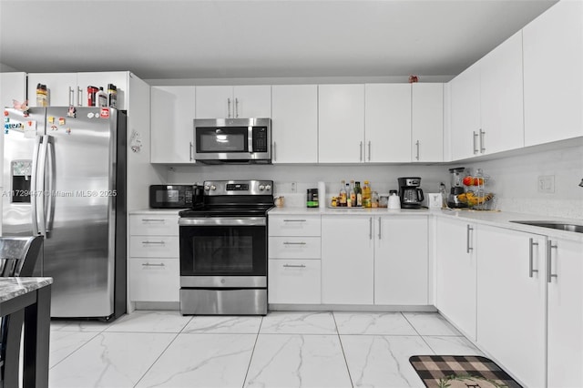 kitchen featuring sink, white cabinetry, and appliances with stainless steel finishes