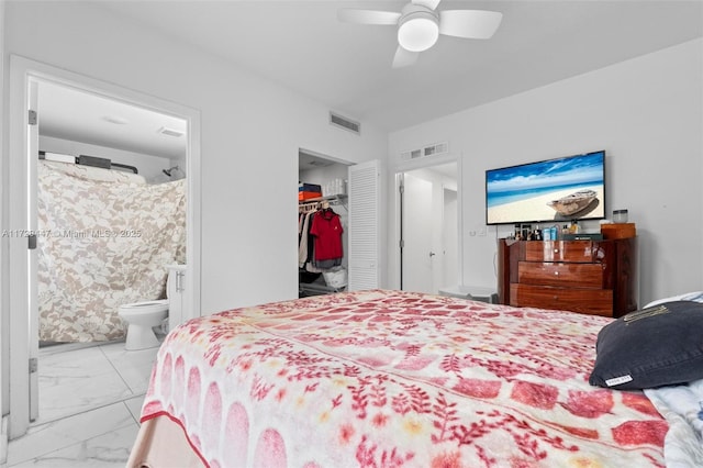 bedroom with a closet, ceiling fan, and ensuite bath