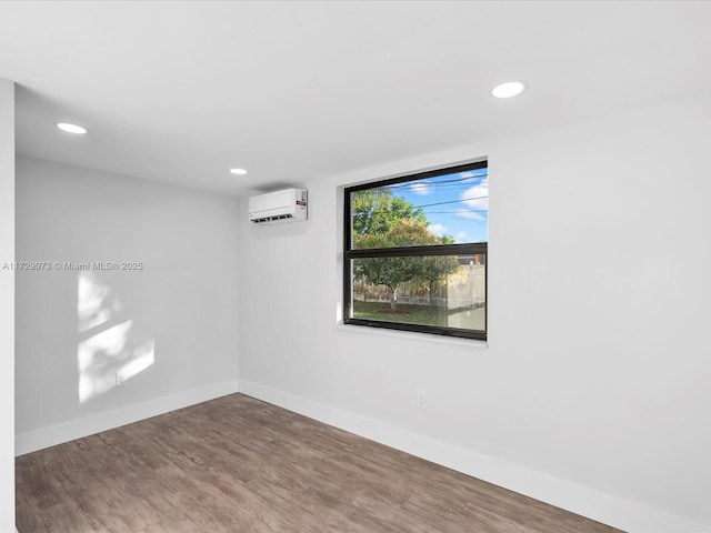 empty room with hardwood / wood-style floors and a wall mounted air conditioner