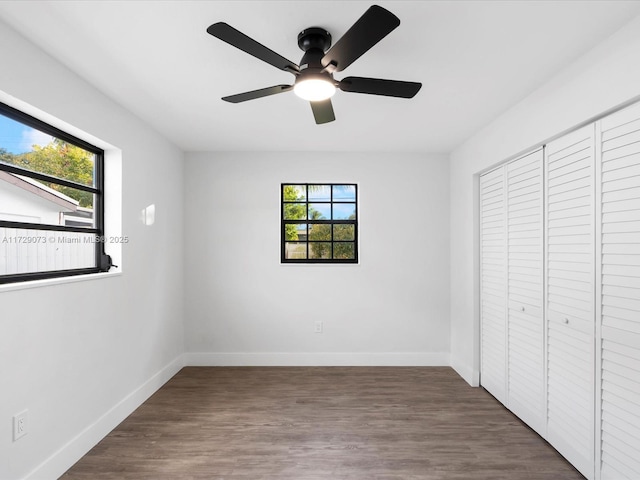 unfurnished bedroom with a closet, ceiling fan, and dark hardwood / wood-style flooring