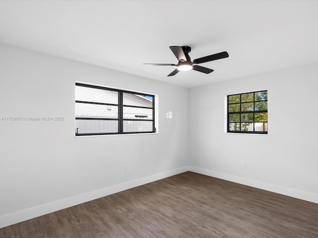 unfurnished room with ceiling fan and dark hardwood / wood-style flooring