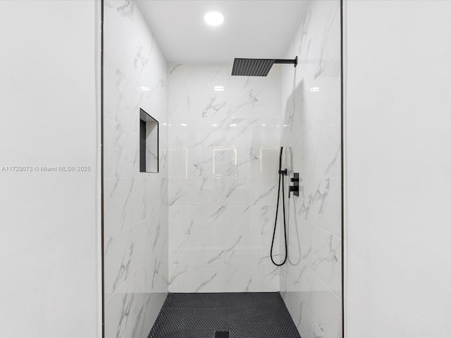 bathroom with tiled shower