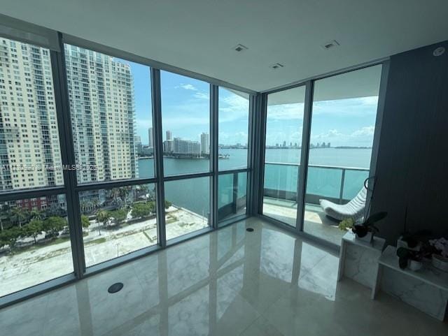 1331 Brickell Bay Dr Unit 1602, Miami, FL 33131 - unfurnished bedroom featuring a water view, expansive windows, multiple windows, and a city view