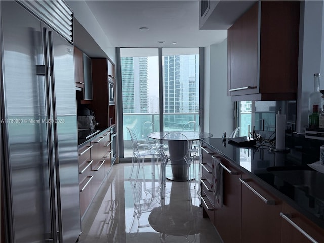 1331 Brickell Bay Dr Unit 1602, Miami, FL 33131 - kitchen featuring built in fridge, modern cabinets, plenty of natural light, floor to ceiling windows, and dark countertops