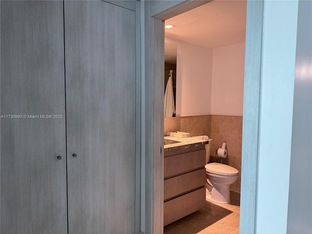 1331 Brickell Bay Dr Unit 1602, Miami, FL 33131 - bathroom with vanity, toilet, tile walls, wainscoting, and tile patterned floors