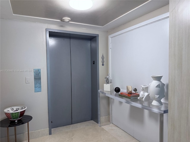 1331 Brickell Bay Dr Unit 1602, Miami, FL 33131 - entryway with elevator, baseboards, and light tile patterned floors