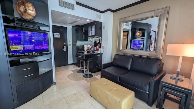 living room featuring bar area and crown molding