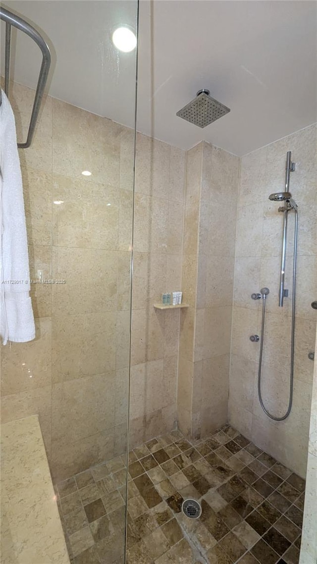 bathroom with tiled shower