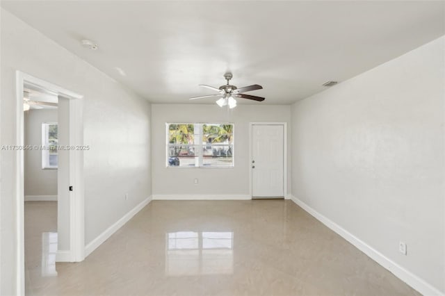 unfurnished room with ceiling fan and plenty of natural light