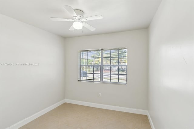 tiled empty room featuring ceiling fan