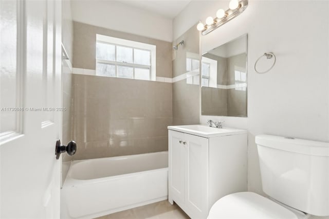 full bathroom featuring vanity, toilet, and tiled shower / bath