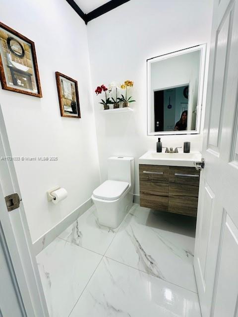 bathroom featuring vanity and toilet