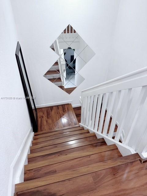 stairs with hardwood / wood-style floors