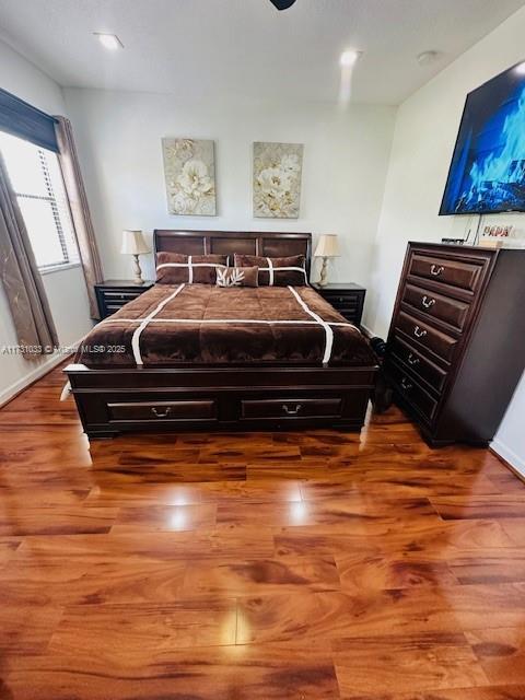 bedroom with hardwood / wood-style floors