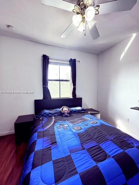 bedroom with hardwood / wood-style flooring and ceiling fan