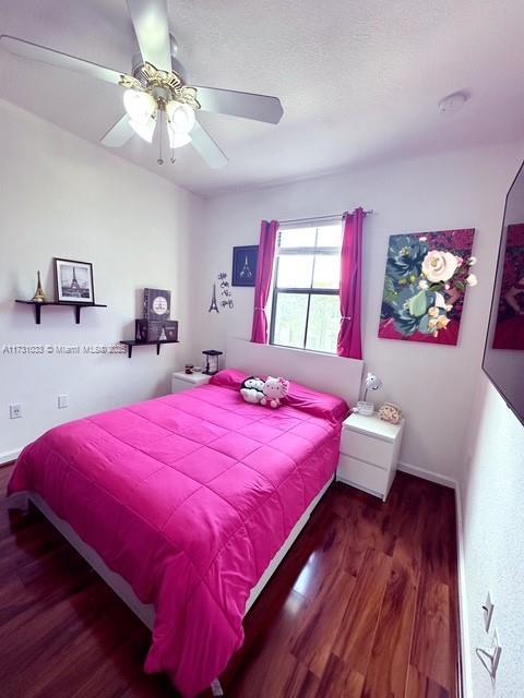 bedroom featuring ceiling fan and hardwood / wood-style floors