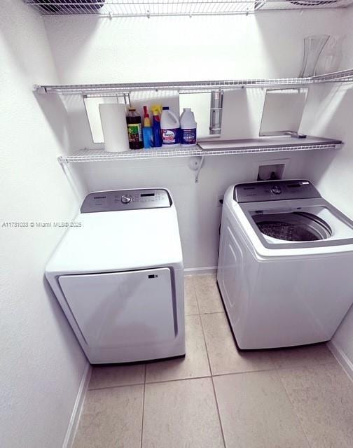 washroom featuring separate washer and dryer and light tile patterned flooring