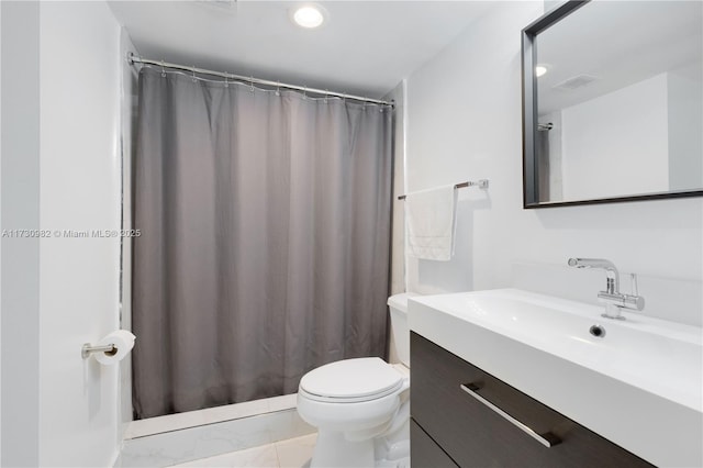 bathroom featuring vanity, tile patterned floors, and toilet