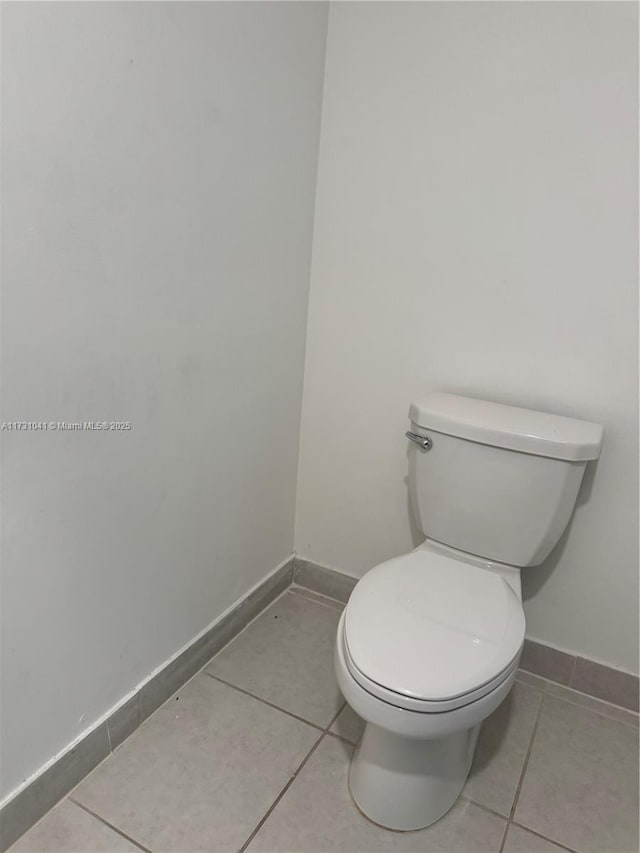 bathroom featuring toilet and tile patterned flooring