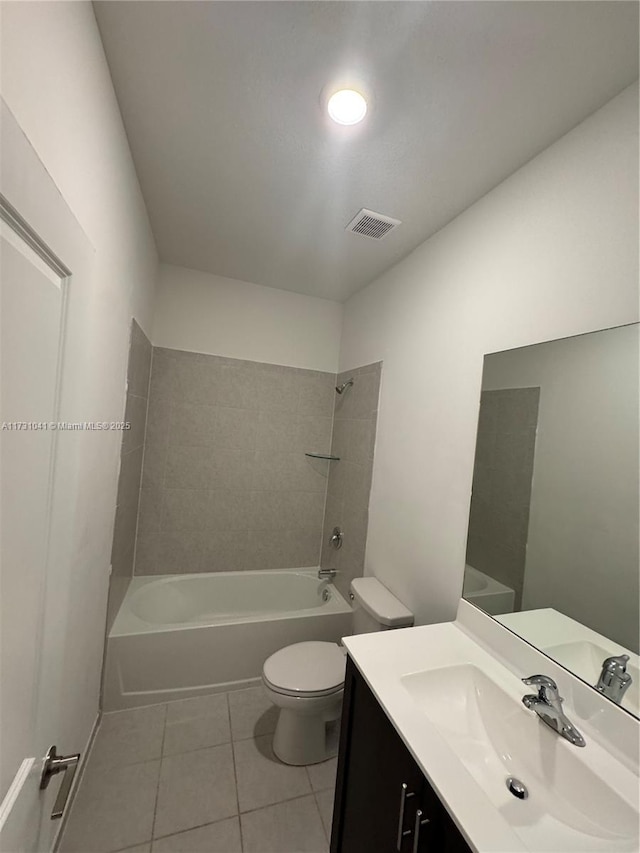 full bathroom with tile patterned flooring, vanity, toilet, and tiled shower / bath