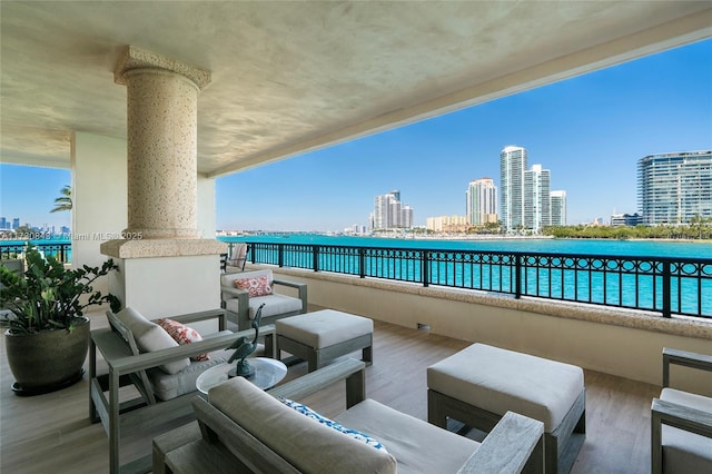 view of patio featuring a balcony and a water view