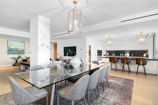 dining space with light wood-type flooring