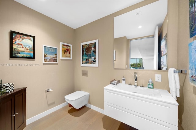 bathroom featuring vanity, wood-type flooring, and toilet