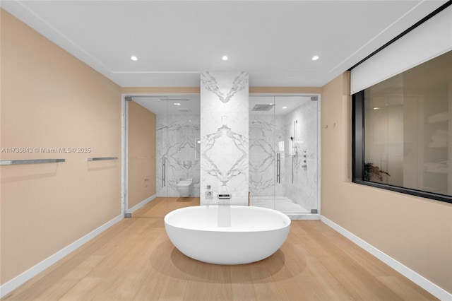 bathroom featuring hardwood / wood-style flooring, toilet, and shower with separate bathtub